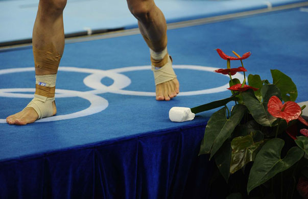 The taped feet of China's Li Xiaopeng at the beijing olympics