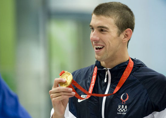 Phelps holds his medal after winning gold 