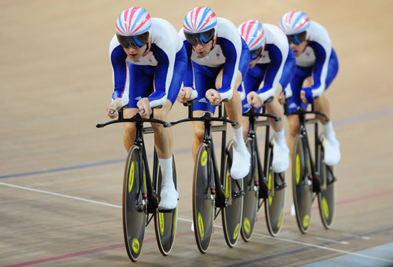 Track cyclists of Great Britain compete in the men's team pursuit qualifying at the Laoshan Velodrome  