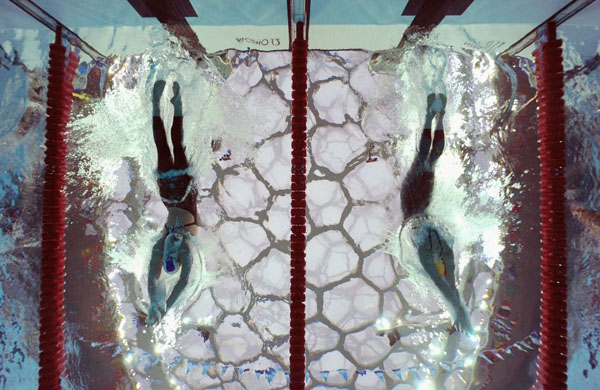 Gemma Spofforth of Great Britain (L) and Emily Seebohm of Australia (R) compete in the backstroke leg of the Women's 4x100 Medley Relay