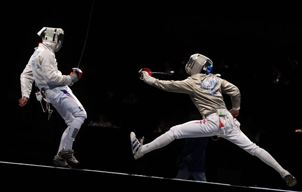 France's Nicolas Lopez (L) and USA's James Williams compete during the men's team sabre gold medal match 