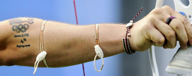 Archer Laurence Godfrey of Britain as he shoots during the men's team competition