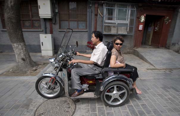 man and woman on a motorbike
