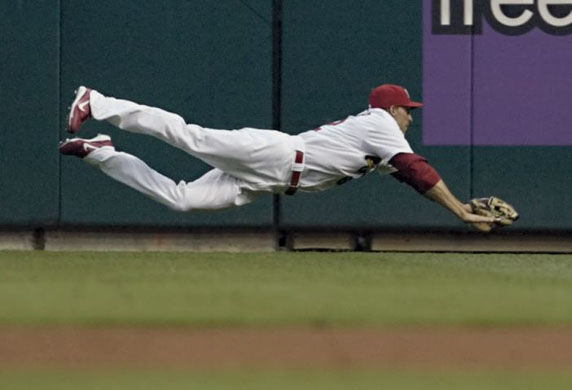 St. Louis Cardinals' Joe Mather stretches out to catch a fly ball hit by Pittsburgh Pirates' Adam LaRoche during the first inning of a baseball match in St. Louis 