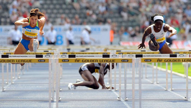 Spanish Onyia (R) and Swedish Kallur (L) shown in action during the 100 metres hurdles competition while Jamaican Ennis-London (C) stumbles at the 67th International Stadionfest 