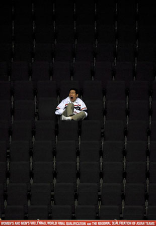 A lonely spectator yawns while watching a volleyball game at the FIVB Men's World Olympic Qualification Tournament