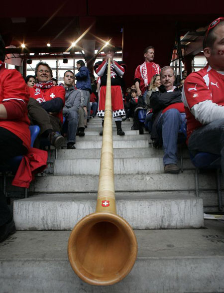 A Swiss fan plays a horn prior to the group A match in Basel 