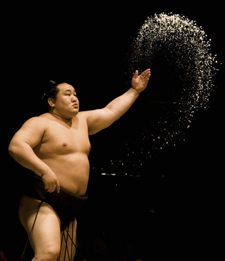 Grand sumo wrestler Asashoryu of Mongolia throws salt before his match in Los Angeles