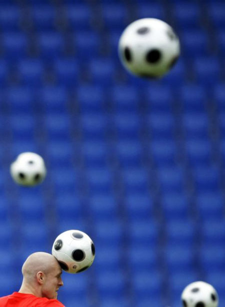 Switzerland's Philippe Senderos heads a ball during a training session in Basel