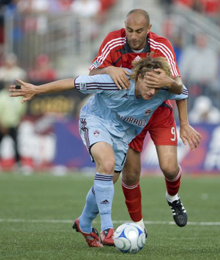 Toronto FC's Danny Dichio (right), tries to tie up Colorado Rapids' Stephen Keel in Toronto