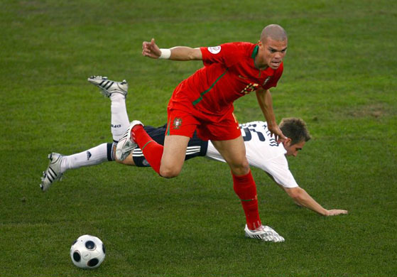 Pepe of Portugal tackles Philipp Lahm of Germany in Basel 