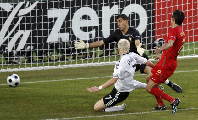 Germany's Bastian Schweinsteiger (L) scores the opening goal in Basel