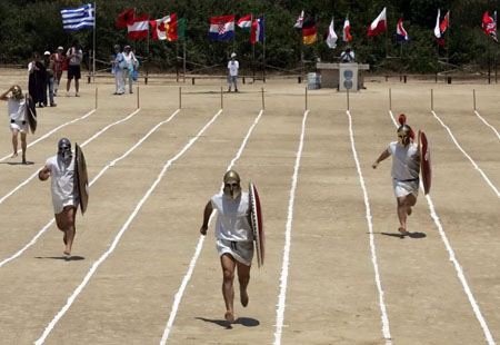 Hoplites run during the hoplitodromos (race in armors) at the ancient stadium in Nemea