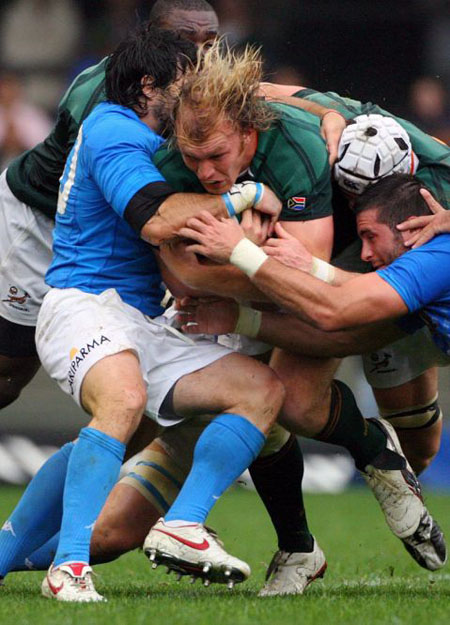 Frans Steyn of South Africa (C) is tackled by Robert Barbieri in Cape Town 