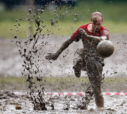 man kixcks the ball during the Swamp Soccer World Championship in Argyll 