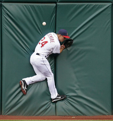 Cleveland Indians' Grady Sizemore jumps into the wall while trying to catch a double hit in Cleveland