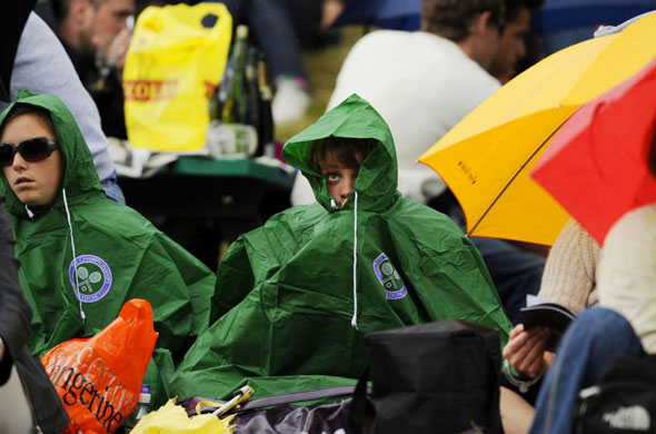 Fans wearing rain-coats