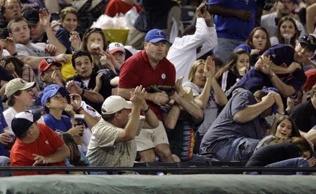 A Texas Rangers fan gets hit by a foul ball
