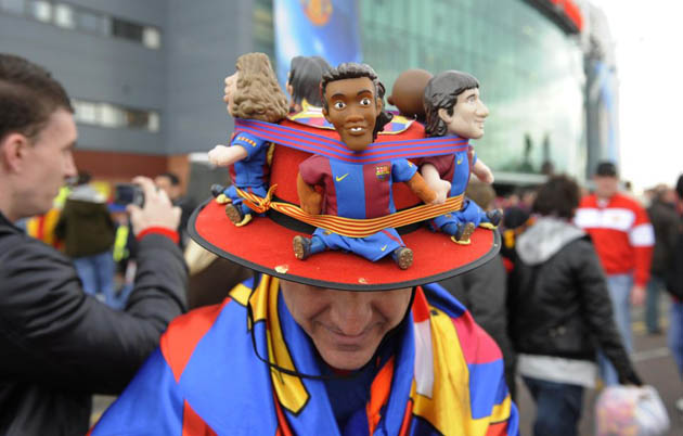 Barca fan with hat of players Puyol, Ronaldinho and Messi