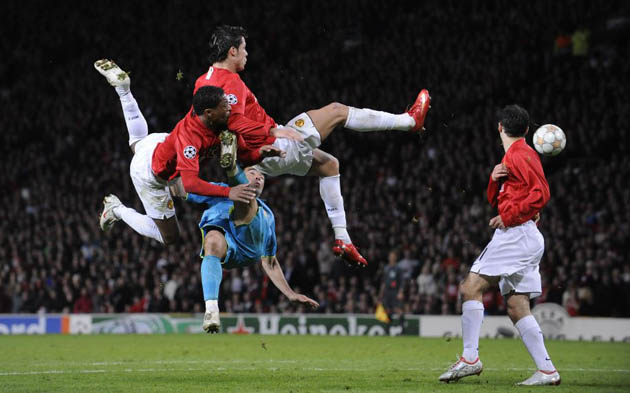 Evra and Ronaldo clear a cross from the foot of Deco