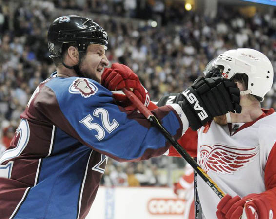 Adam Foote of the Colorado Avalanche and Kris Draper of the Detroit Red Wings get into a shoving match 