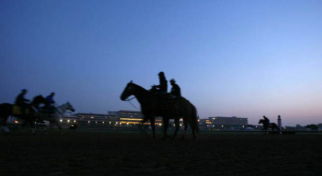Exercise riders walk their horses at Churchill Downs