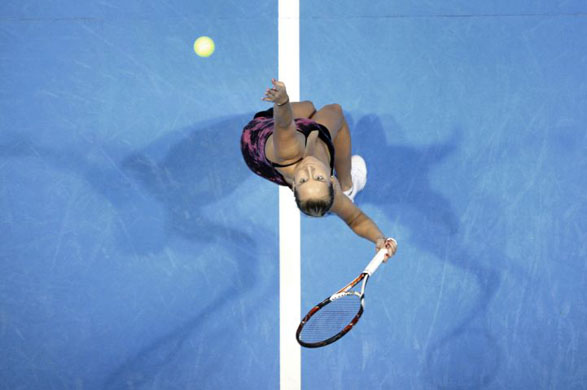 Bethanie Mattek serves against Nadia Petrova during the final of the Bell Challenge tennis tournament 