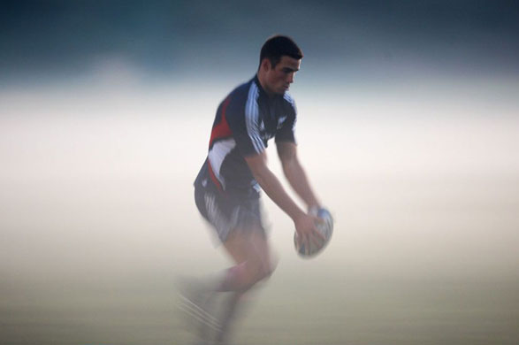 Richard Kaui emerges from the fog during a New Zealand All Blacks training session  