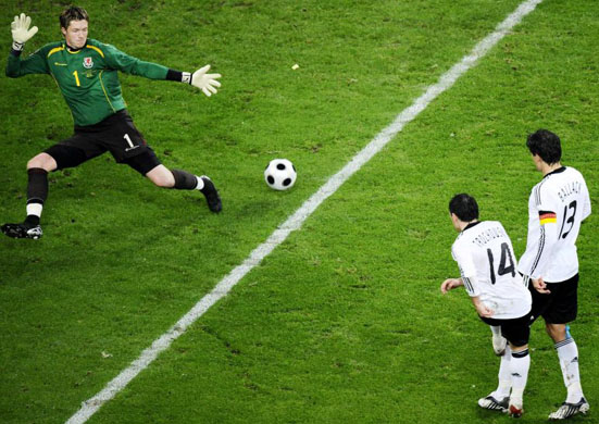 Piotr Trochowski shoots at Wales' goalkeeper Wayne Hennessey during their World Cup qualifier