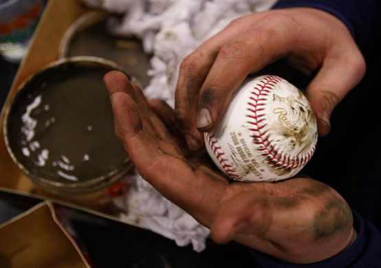 rubbing mud into a baseball