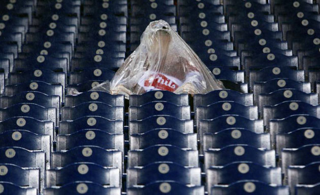 A fan shelters under plastic