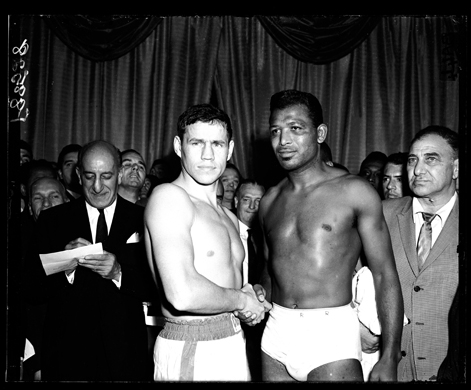 1962: Terry Downes and Sugar Ray Robinson shake hands at the weigh-in for their middleweight boxing match at the Hippodrome