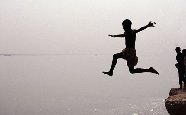 A boy jumps into the Ganges in Bangladesh