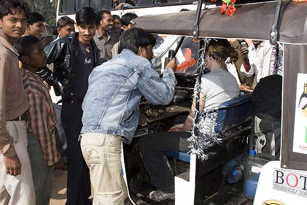 Locals taking photos of rickshaw