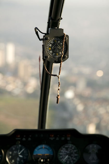 Rosemary hangs on borad of helicopteer over Sao Paulo