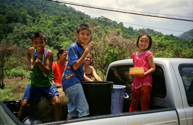 Children having a water fight in Thailand