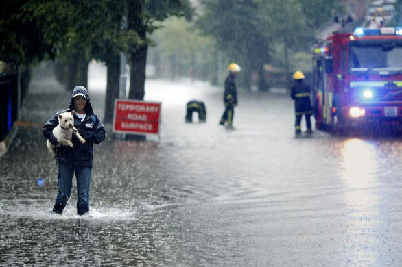 A woman makes her way through floodwaters in the Park Road area of East Belfast
