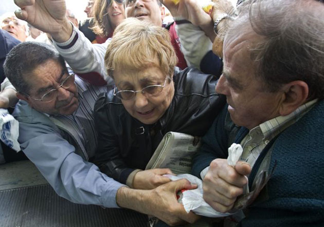  People fight for free fish during a protest in Madrid