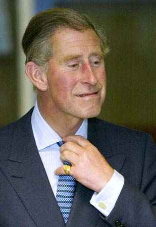 Prince Charles adjusts his tie
