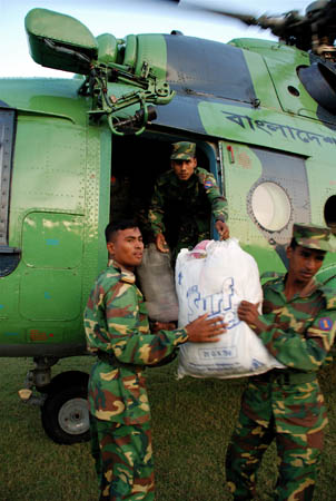 Soldiers at Jhalo Khati unload food and clothes from a Bangladeshi air