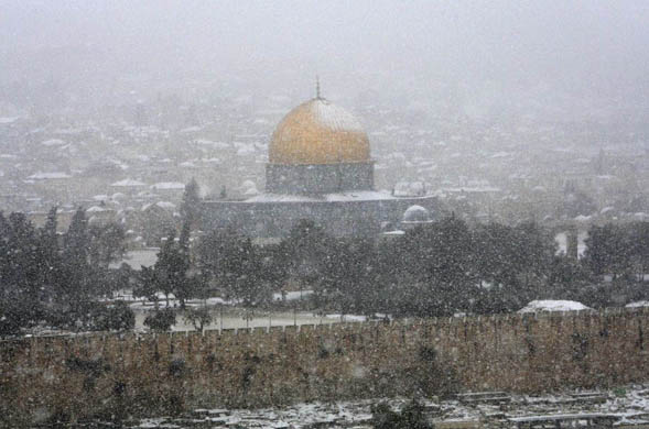 A blizzard hides the view of the golden Dome of the Rock