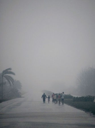 Herradura, Cuba: Residents walk in the rain following Hurricane Ike