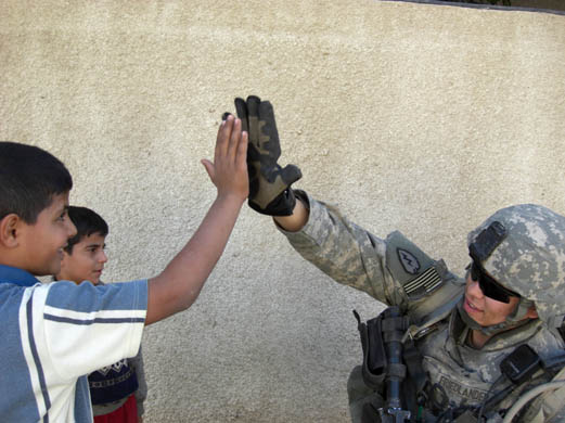 A soldier from the 3rd battalion meets Iraqi children whilst on patrol in al-Hadar