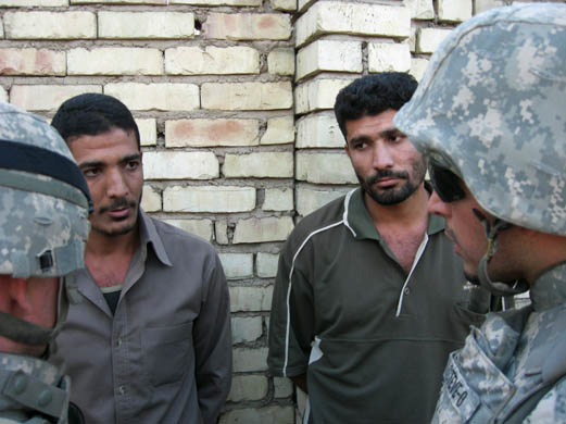 Suspects are questioned by soldiers who had just discovered them near a secret bomb-making factory in an unfinished house in al-Hadar