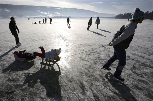 People walking and skating on lake Joux