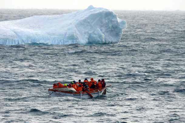 Passengers pass an iceberg
