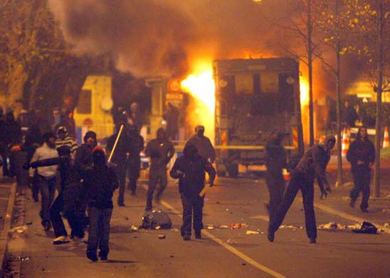 Police and rioters face each other