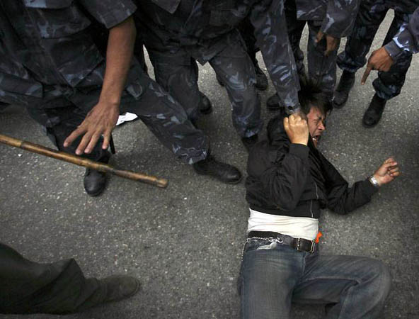 Katmandu, Nepal: Police detain a protester as Tibetans demonstrate against outside the Chinese Embassy