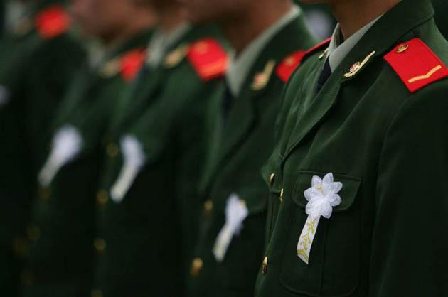 Xian, China: Fire policemen attend a memorial service for martyrs at Xian Martyrs' Cemetery