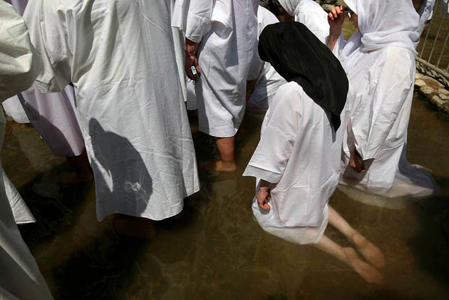 Yardenit, Israel: Romanian Christian pilgrims hold a baptism ceremony in the waters of the Jordan river